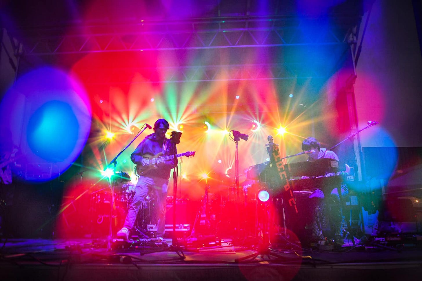 May be an image of one or more people, people playing musical instruments, people standing, guitar and indoor