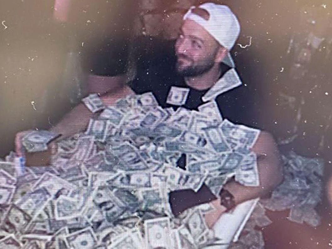 CDCROP: Gary Harmon in a tub full of money. (U.S District Court for the District of Columbia)