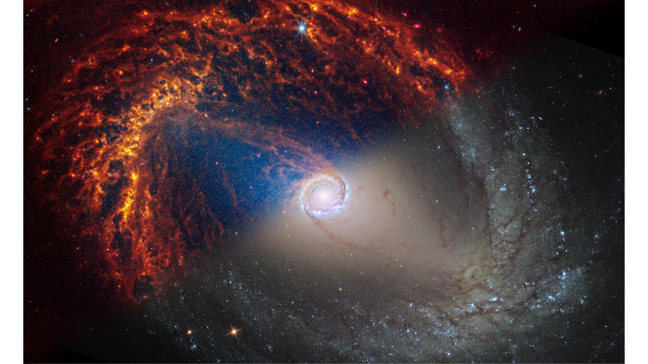 Two observations of the galaxy NGC 1512 are split diagonally, with Webb’s observations at top left and Hubble’s at bottom right. The galaxy’s core is centered and circular, with two prominent dust lanes crossing the large diagonal bar structure appearing toward the top left and bottom right. The central bar is blue at top, looking like a gap until a closer examination shows it feeds a larger, oval shape that looks braided with many spiral arms. In Webb’s image, the spiral arms are composed of many filaments in shades of orange. In Hubble’s image the bar is a light pinkish-brown and the spiral arms are a mix of bright blue star clusters and dark brown dust lanes, Click View Description for additional details.