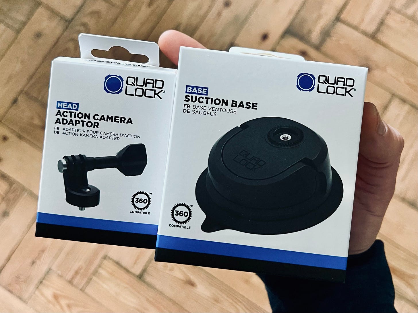 Two boxes are being held. Both of them from Quad lock. One contains an action camera adapter which sits on top of the suction base in the second box. They were sent to me free of charge by quad lock and although I have stuck the suction mount to the window to test it's strength (it's strong very strong), I will not have the time to do a full test just yet.