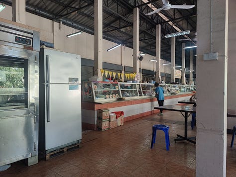 inside the Chamlong's food hall, inside the attached vegetarian store, outside the building