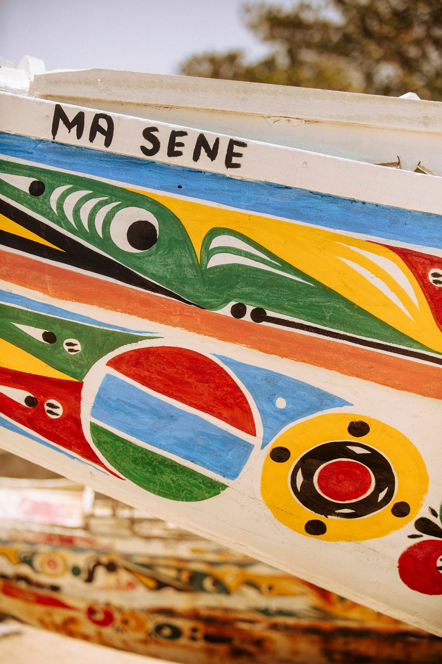 A colourful fishing boat with the words 'Ma Sene' painted on it