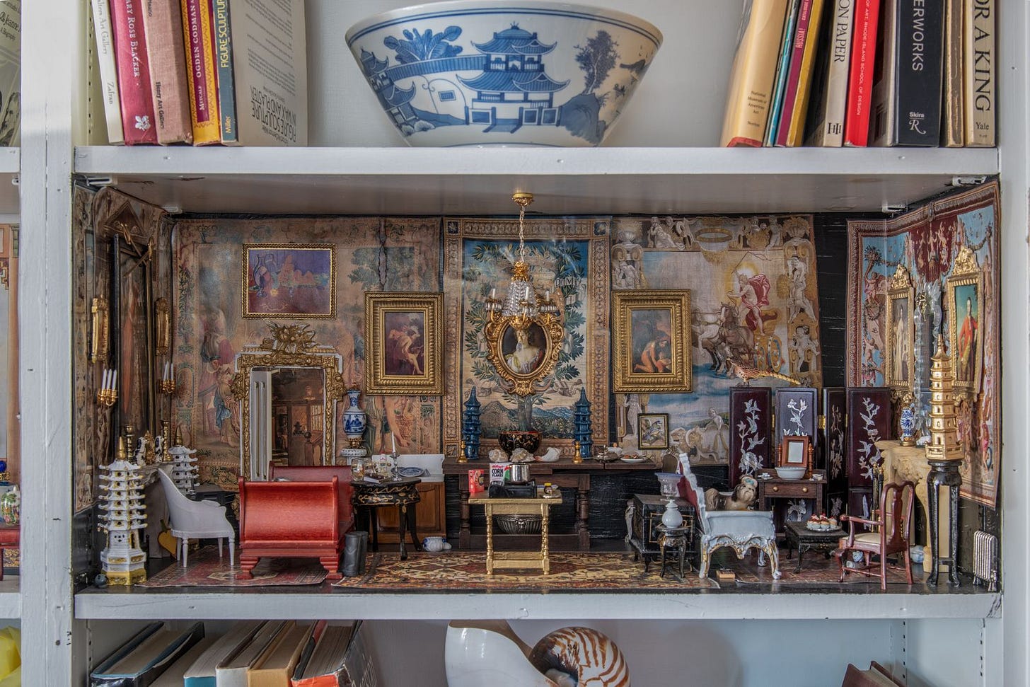 Image may contain Home Decor Chair Furniture Art Painting Desk Table Indoors Interior Design Person and Cup