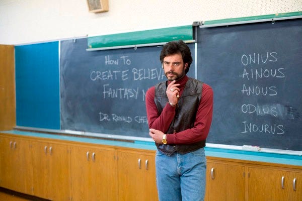 A man stands in front of a blackboard with the message "How to create believable fantasy names" and a list of names. From the film Gentleman Broncos. A man stands in front of a blackboard with the message "How to create believable fantasy names" and a list of names. From the film Gentleman Broncos.