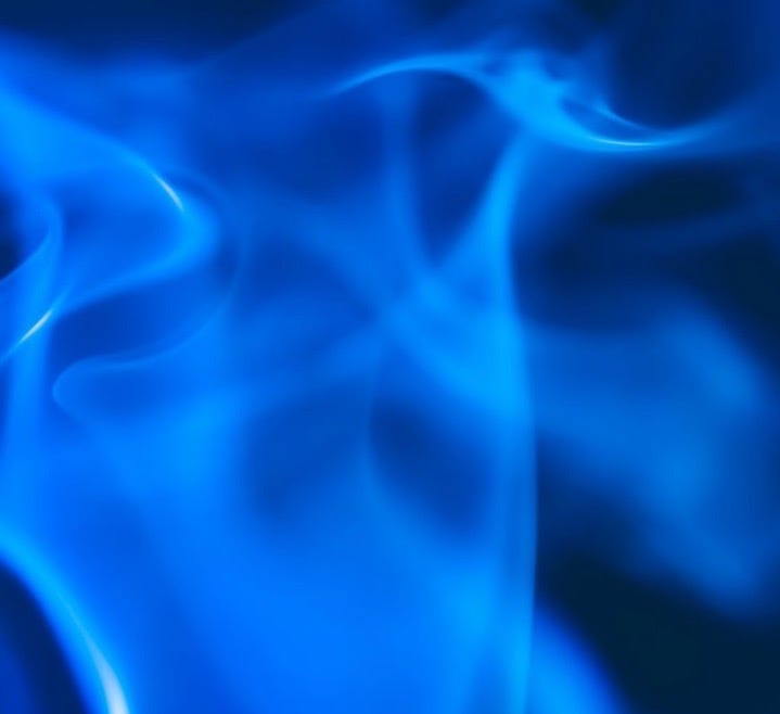 a blue smoke swirls across a black background