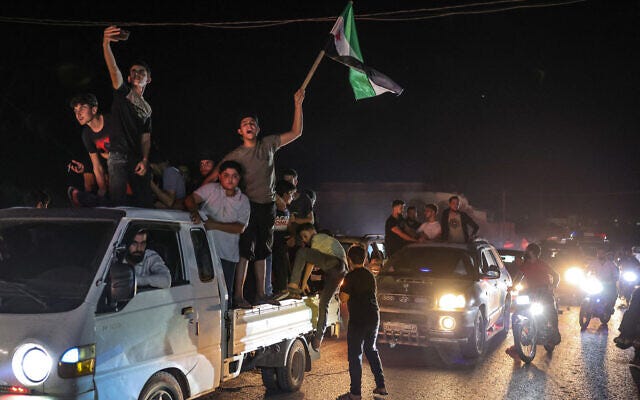 Syrians gather in the rebel-held northwestern city of Idlib celebrate news claiming the death of Lebanon's Hezbollah chief Hassan Nasrallah in an Israeli airstrike on Beirut the day before, September 28, 2024, . (Omar HAJ KADOUR / AFP) Syrians gather in the rebel-held northwestern city of Idlib celebrate news claiming the death of Lebanon's Hezbollah chief Hassan Nasrallah in an Israeli airstrike on Beirut the day before, September 28, 2024, . (Omar HAJ KADOUR / AFP)