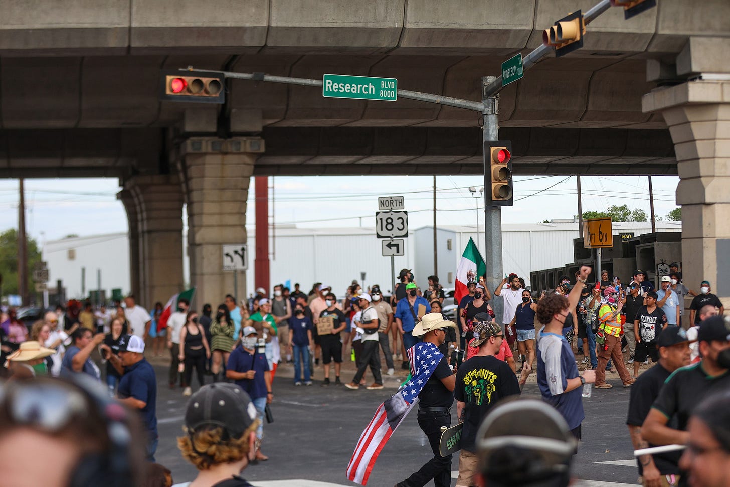 Protesters fill the intersection of West Anderson and Research Boulevard after an immigration enforcement agent shot and injured Venezuelan Wilber Rafael Garces Perez on Sunday Sept. 20, 2026. (Photo by Jacob Lujan/The Texas Tribune) Protesters fill the intersection of West Anderson and Research Boulevard after an immigration enforcement agent shot and injured Venezuelan Wilber Rafael Garces Perez on Sunday Sept. 20, 2026. (Photo by Jacob Lujan/The Texas Tribune)
