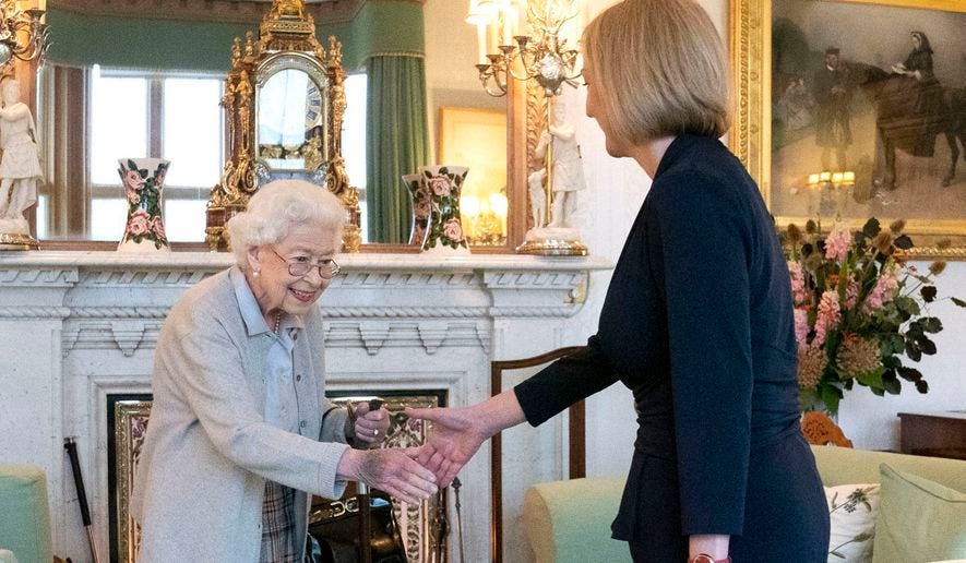 Britain&#x27;s Queen Elizabeth II, left, welcomes Liz Truss during an audience at Balmoral, Scotland, where she invited the newly elected leader of the Conservative party to become Prime Minister and form a new government, Tuesday, Sept. 6, 2022. (Jane Barlow/Pool Photo via AP)