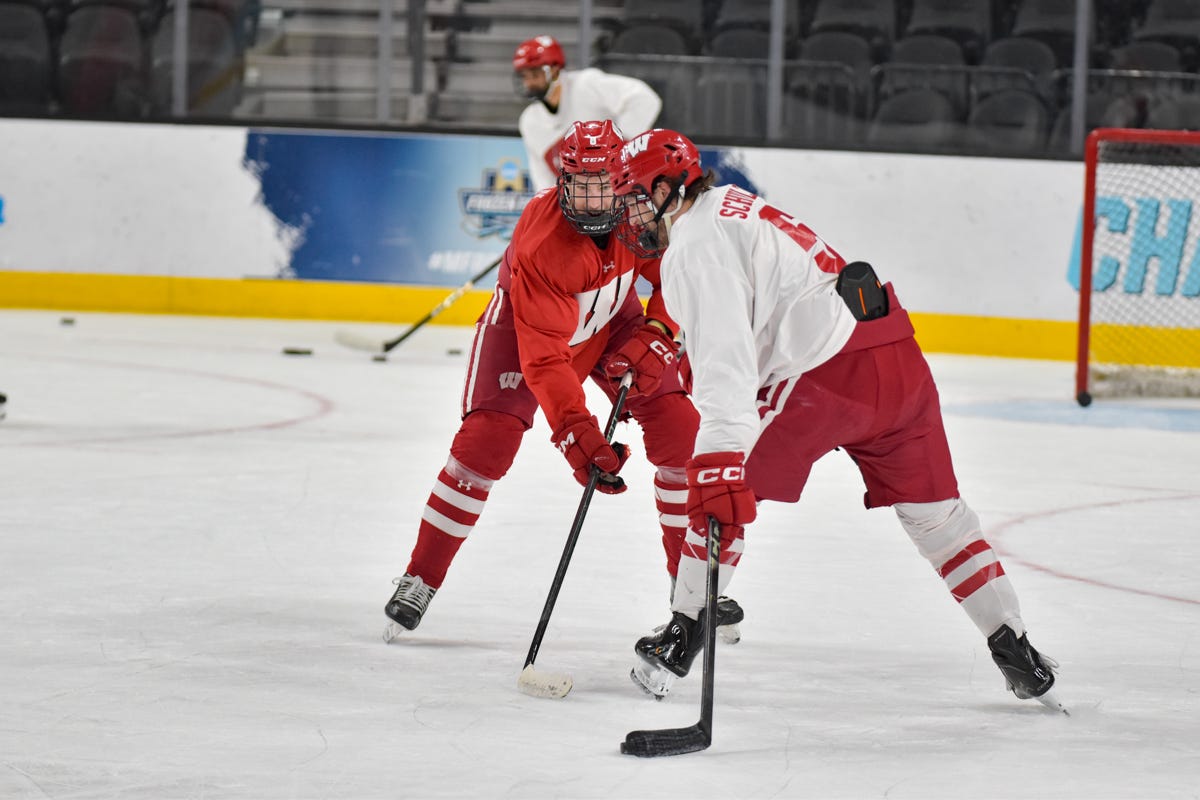 Jack Phelan and Zach Schulz defense practice sticks on left side of body