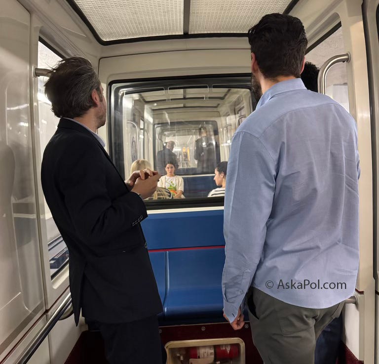 Young men on a tram car look out the window. Photo TheLCB.com © Ask a Pol Young men on a tram car look out the window. Photo TheLCB.com © Ask a Pol