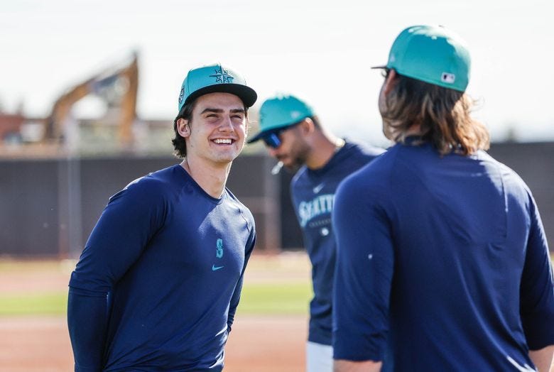 Infielder Cole Young talks with his new Mariner teammates Tuesday in Arizona.  The Seattle Mariners opened Spring Training for the full squad Tuesday, Feb. 20, 2024 at the Peoria Sports Complex, in Peoria, AZ. (Dean Rutz / The Seattle Times)