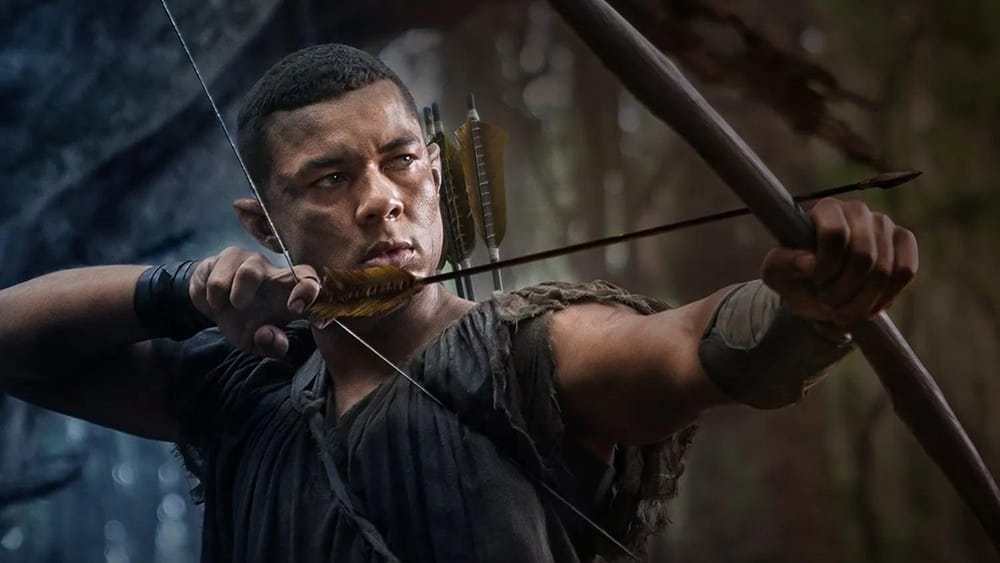 An elven archer takes aim with his bow