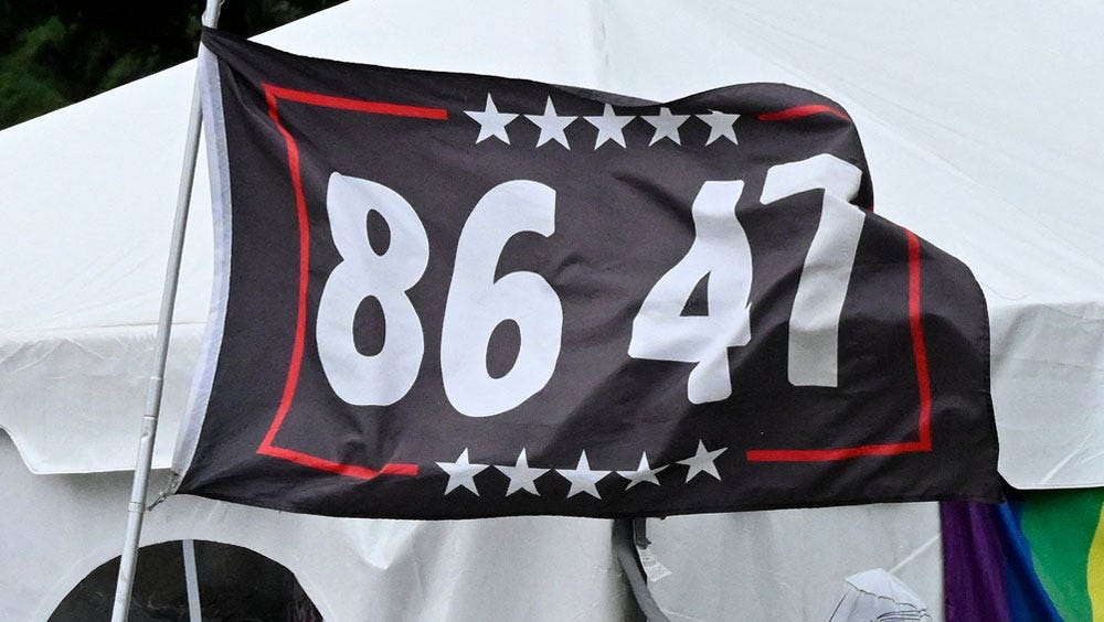 A dark blue flag with a border of white stars and red lines says "86 47" A dark blue flag with a border of white stars and red lines says "86 47"