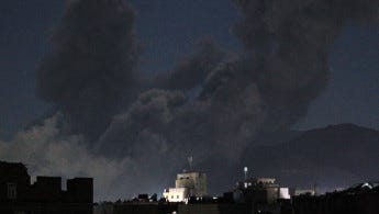 A plume of smoke billows during a US strike on Yemen's Huthi-held capital Sanaa early on March 16, 2025. (Photo by MOHAMMED HUWAIS/AFP via Getty Images)