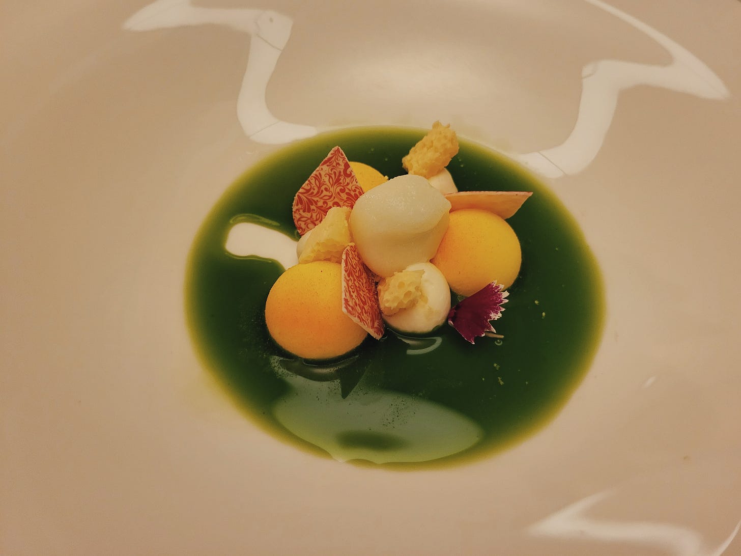 Plated dessert in bright green sauce at Kitchen in Lake Como Plated dessert in bright green sauce at Kitchen in Lake Como