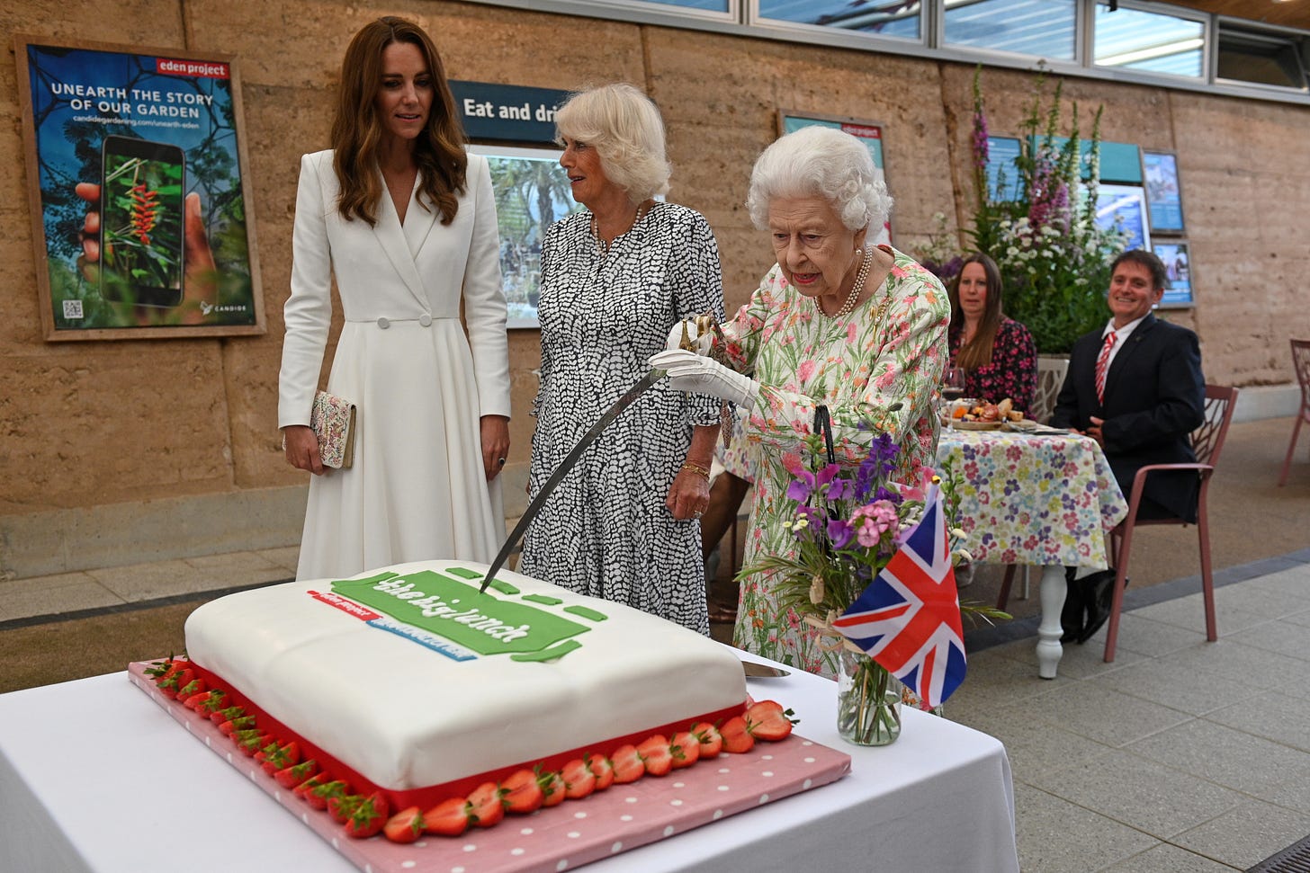Princess Catherine, Camilla and the late Queen cutting a cake