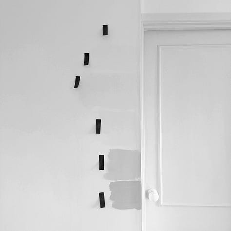Photographs of a white door and wall with paint samples of different white paints with orange post it notes labelling the paint colours
