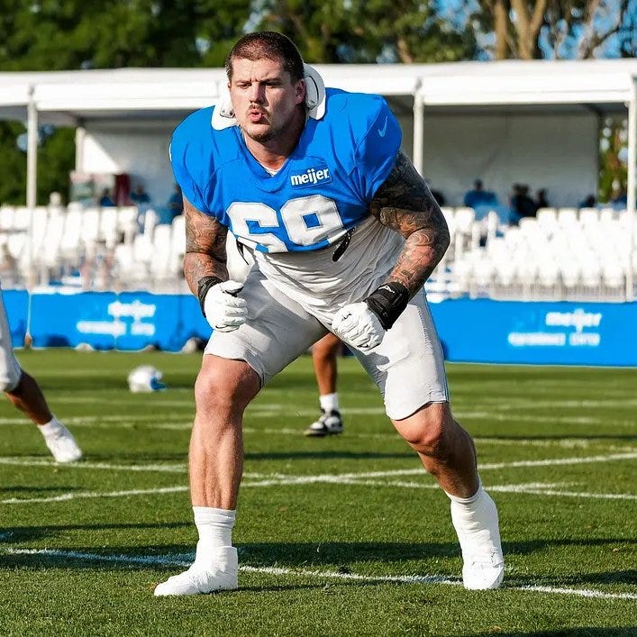 Tate Ratledge at Detroit Lions 2026 training camp wearing neck roll Tate Ratledge at Detroit Lions 2026 training camp wearing neck roll