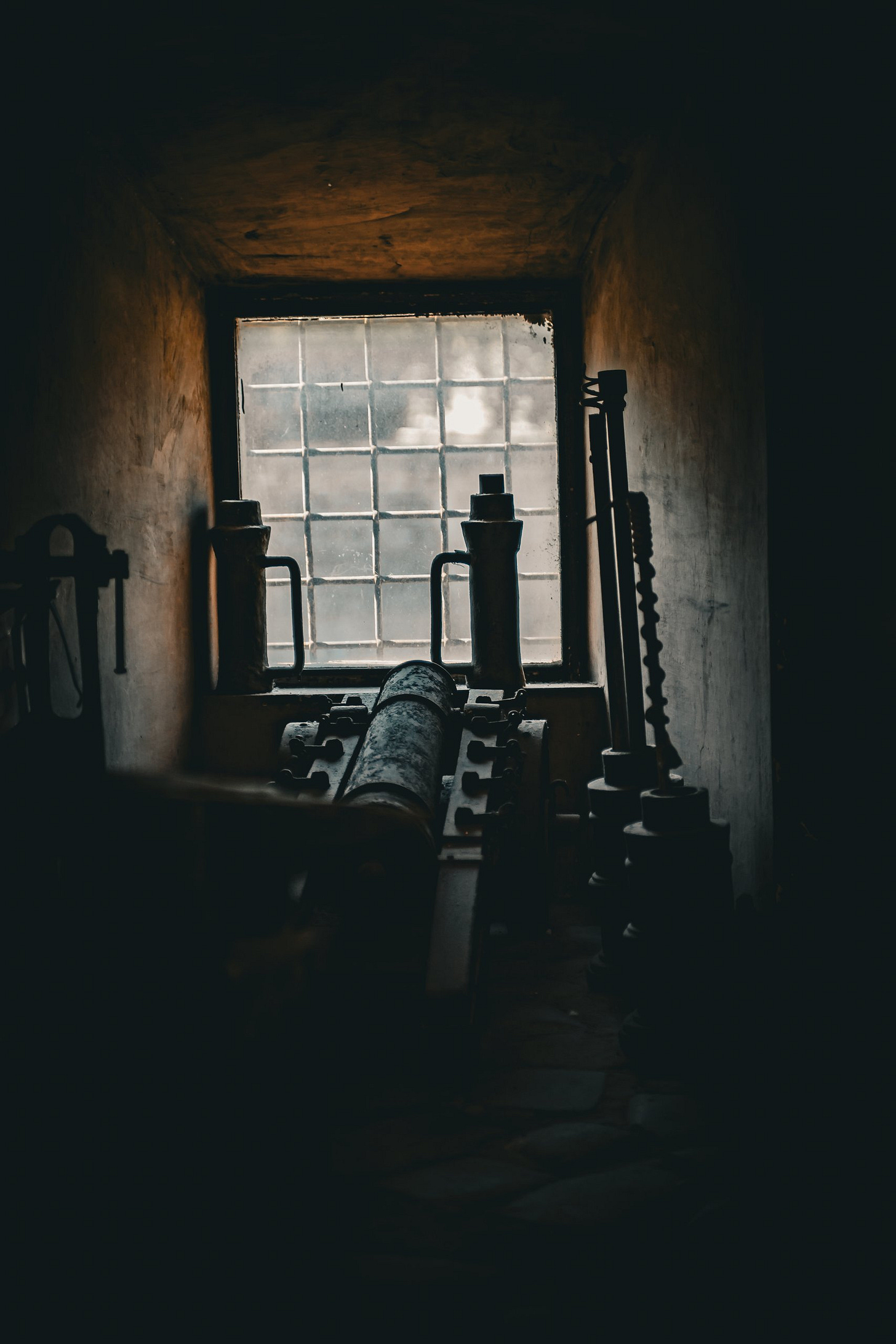 Old Cannon in Dimly Lit Room