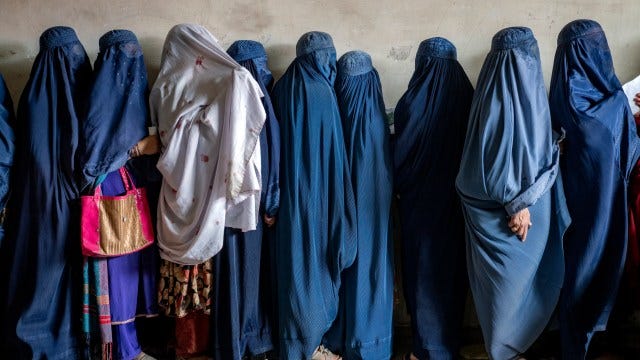 FILE - Afghan women wait to receive food rations distributed by a humanitarian aid group, in Kabul, Afghanistan, Tuesday, May 23, 2023. In a report issued on Monday, July 17, 2023, the U.N. says Taliban authorities have further increased restrictions on the rights of women and girls in Afghanistan in recent months. (AP Photo/Ebrahim Noroozi, File)