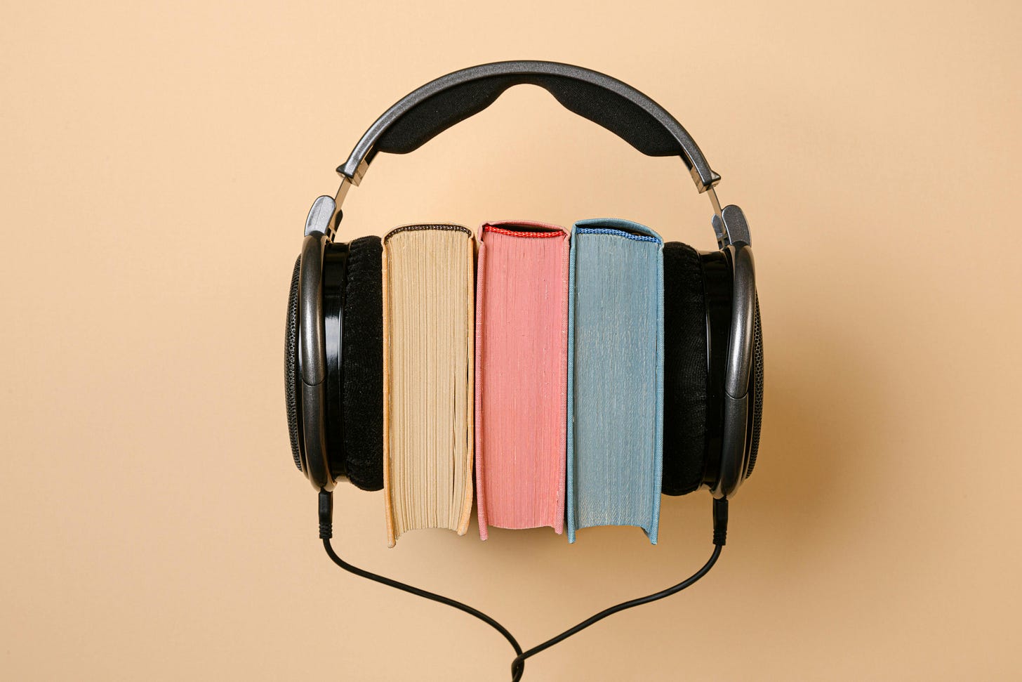 books and headphones on a peach-colored background books and headphones on a peach-colored background