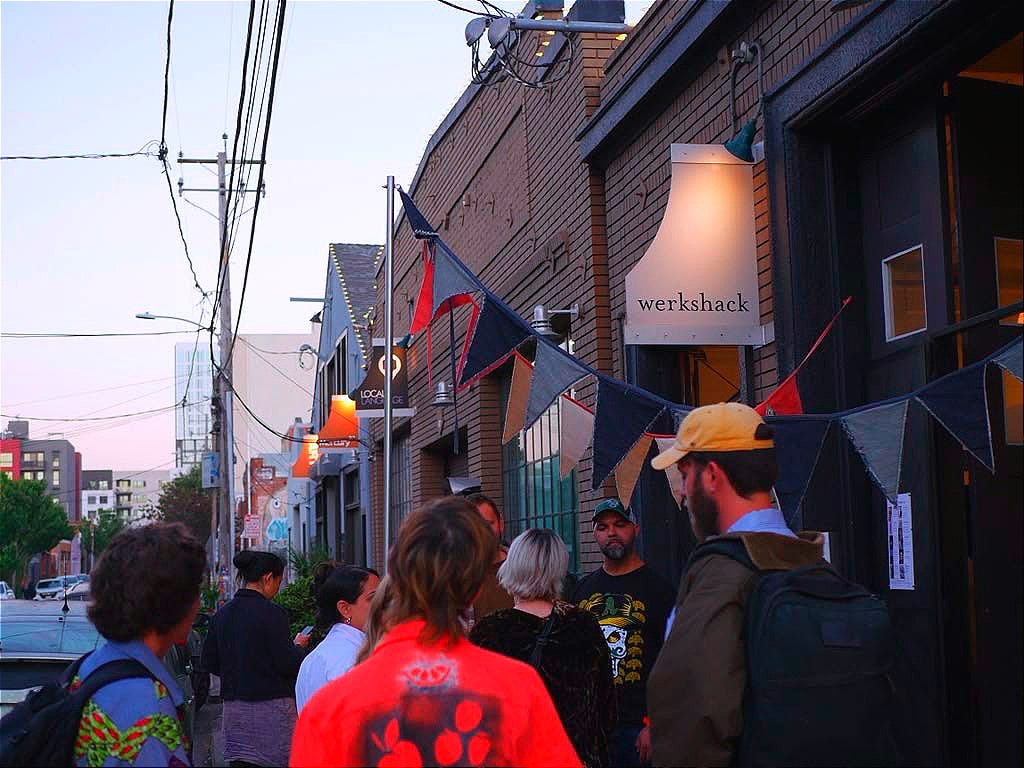 A crowd gathers outside the Gallery at the Werkshack on 25th Street in Oakland for the Society of Artists & Makers Student Show. (Image source: Raha Banoo) A crowd gathers outside the Gallery at the Werkshack on 25th Street in Oakland for the Society of Artists & Makers Student Show. (Image source: Raha Banoo)
