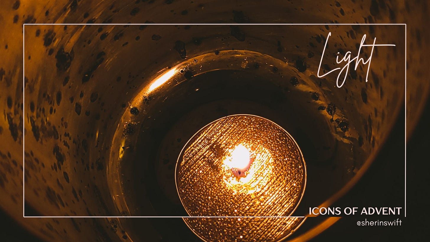 A picture of a lit candle in a golden candle holder.