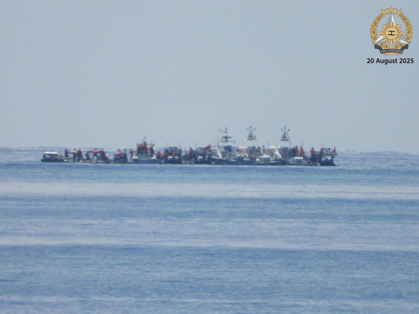 At least 10 small Chinese patrol boats viewed from a distance anchored at Second Thomas Shoal. At least 10 small Chinese patrol boats viewed from a distance anchored at Second Thomas Shoal.