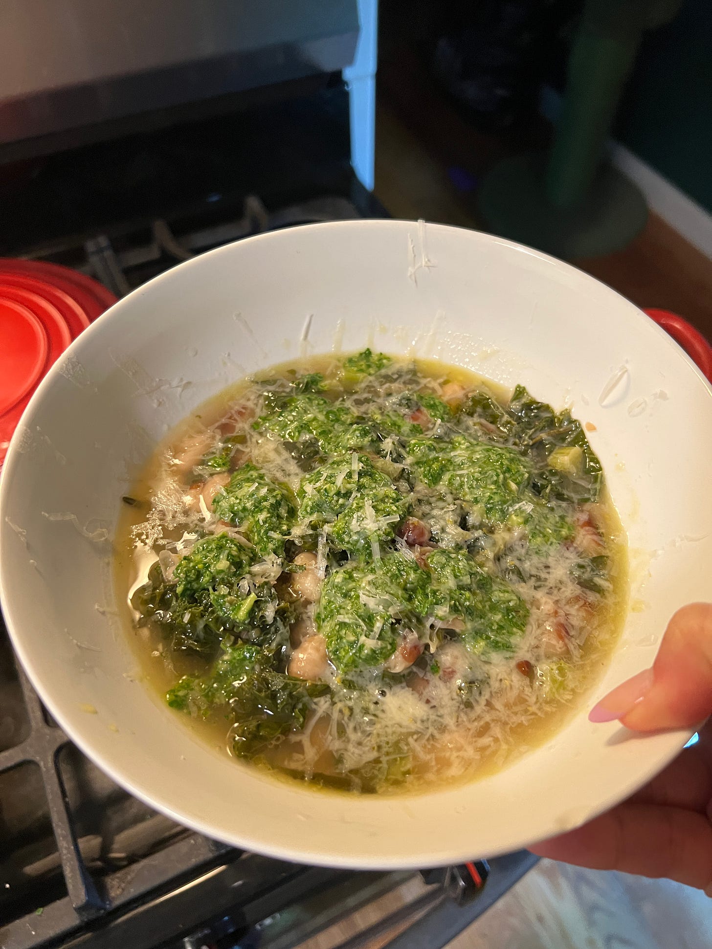 a bowl of soup with green pesto
