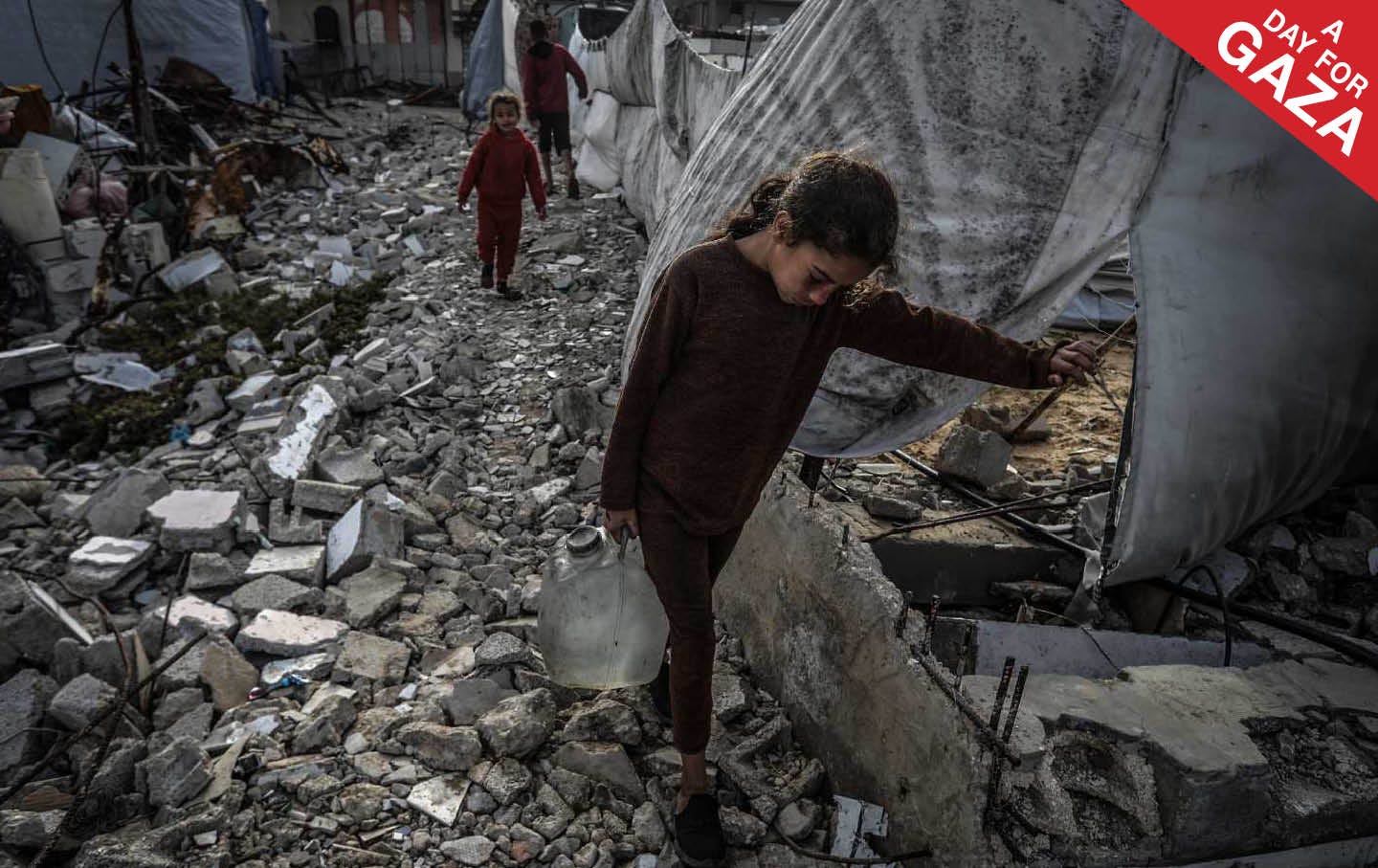 A Palestinian girl carries a gallon of drinking water she filled from a water truck in Khan Younis. Palestinians in Gaza are suffering from a severe water crisis due to the destruction of water wells by Israeli air strikes.