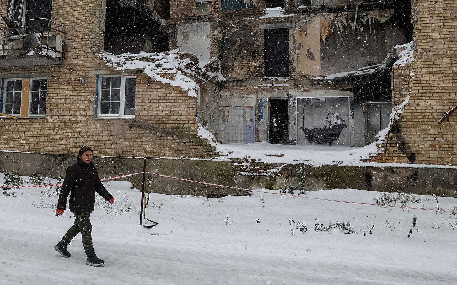 Tetiana Reznychenko in Horenka, in front of the wall where the two men painted. Photo: Reuters