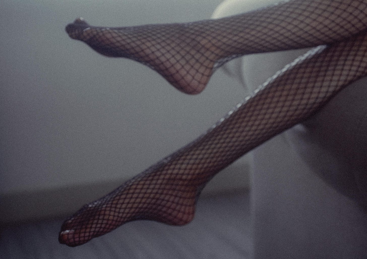 A pair of legs in fishnet stockings