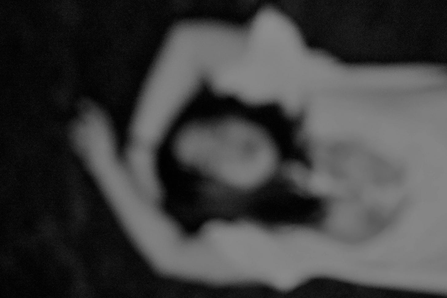 A hazy photo of a woman lying on a sofa A hazy photo of a woman lying on a sofa