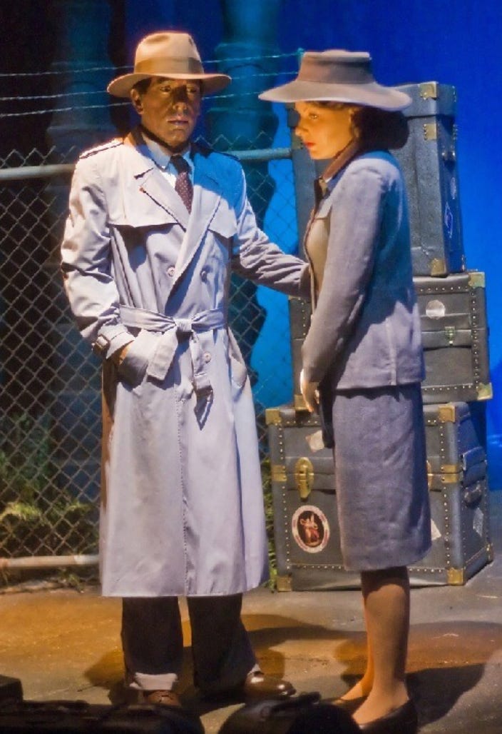 A person and person in trench coats

Description automatically generated