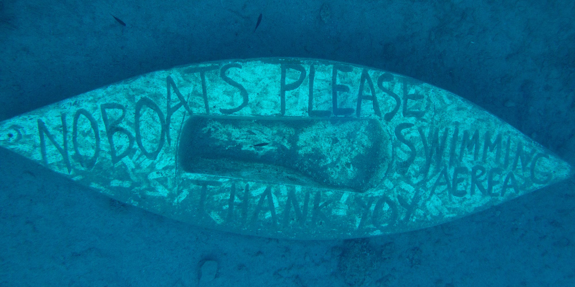 Sunken boat at Hydra, Greece representing writers skimming the surface before diving deep.