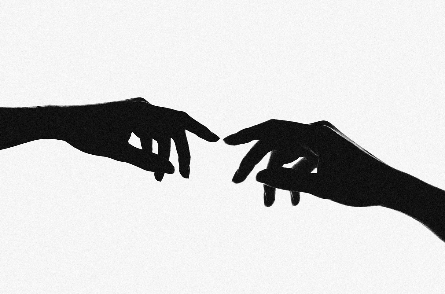 Image of two hands in silhouette, reaching toward each other Image of two hands in silhouette, reaching toward each other