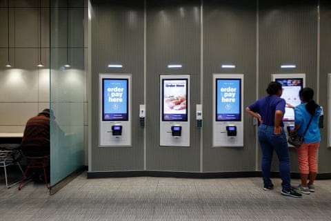 McDonald’s customers in New York order at a digital kiosk. McDonald’s customers in New York order at a digital kiosk.