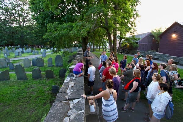 A tour group at the Salem Witch Trials Memorial in Salem, Mass. A tour group at the Salem Witch Trials Memorial in Salem, Mass.