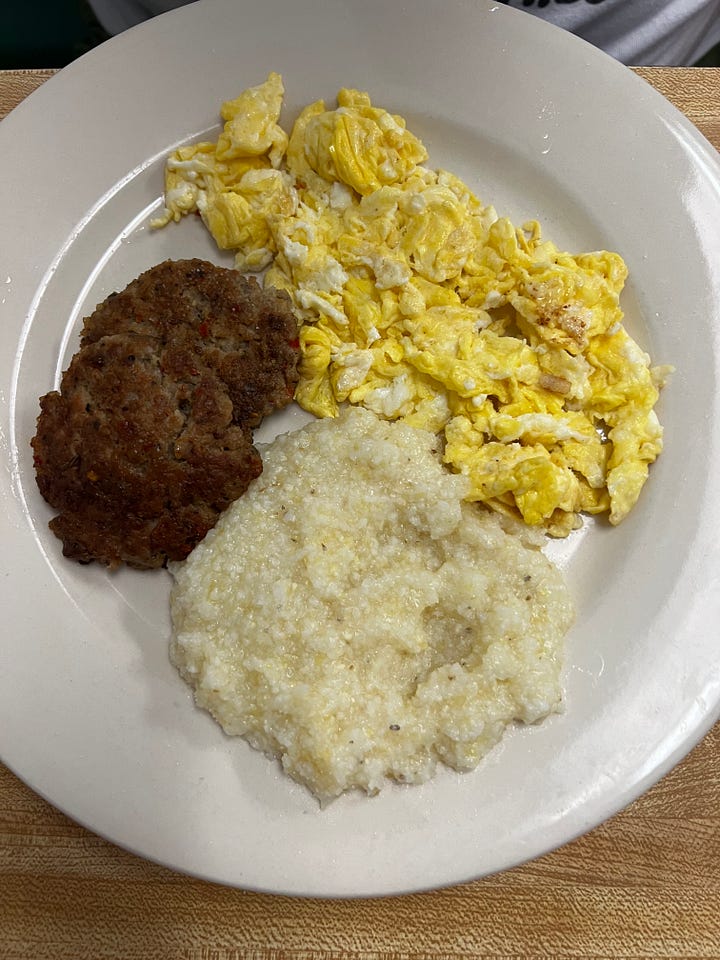two plates of eggs, sausage, hash browns, and grits