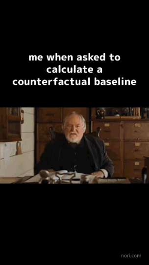 Animated. Text: "me when asked to calculate a counterfactual baseline." An old bearded man sits behind a cluttered desk in a wood-panelled study, talking.
