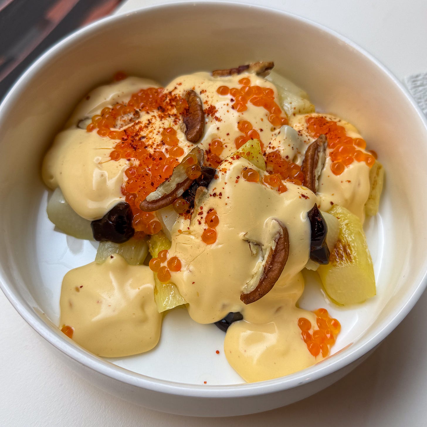 White asparagus with Espelette sabayon, trout eggs, walnuts, and fermented black garlic at Argile, Paris 9th White asparagus with Espelette sabayon, trout eggs, walnuts, and fermented black garlic at Argile, Paris 9th