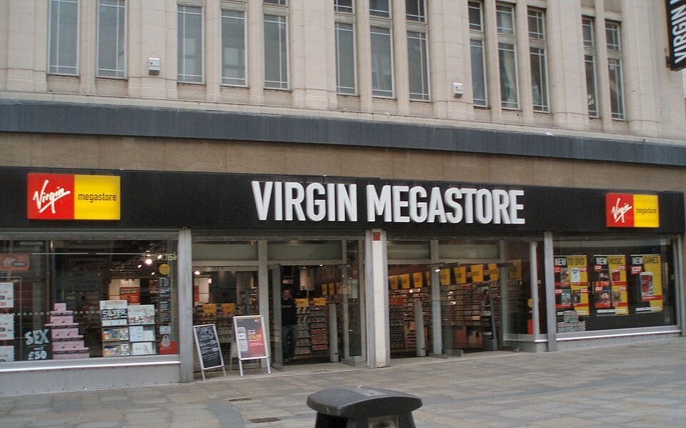 Virgin Megastore on Northumberland Street, Newcastle taken in 2007 - the shop has loads of CDs and other physical media inside the windows, the logo is red and yellow.