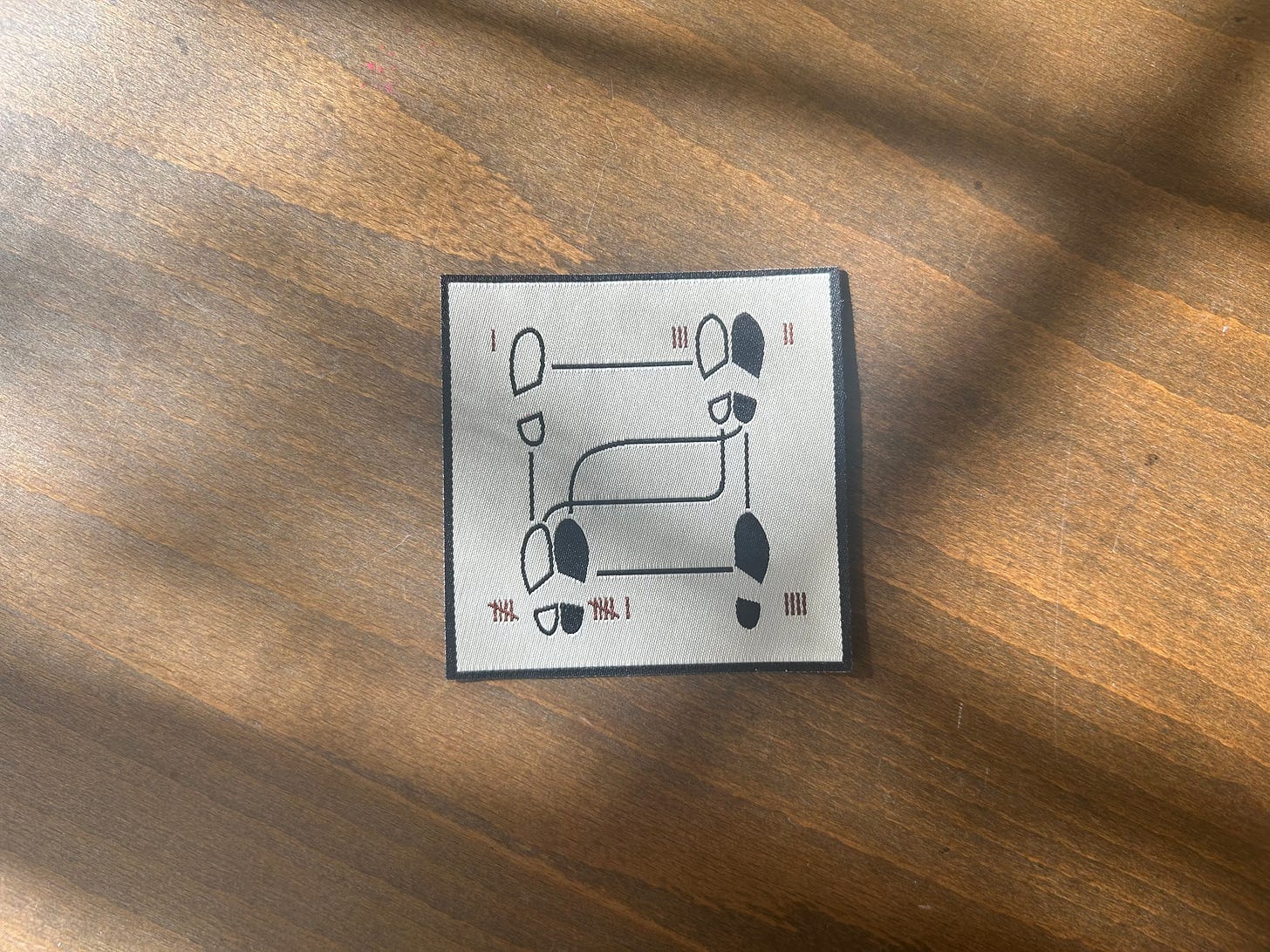 Fabric patch of a dancing diagram, made by Brit Hutchinson, Tinycup Needleworks Fabric patch of a dancing diagram, made by Brit Hutchinson, Tinycup Needleworks