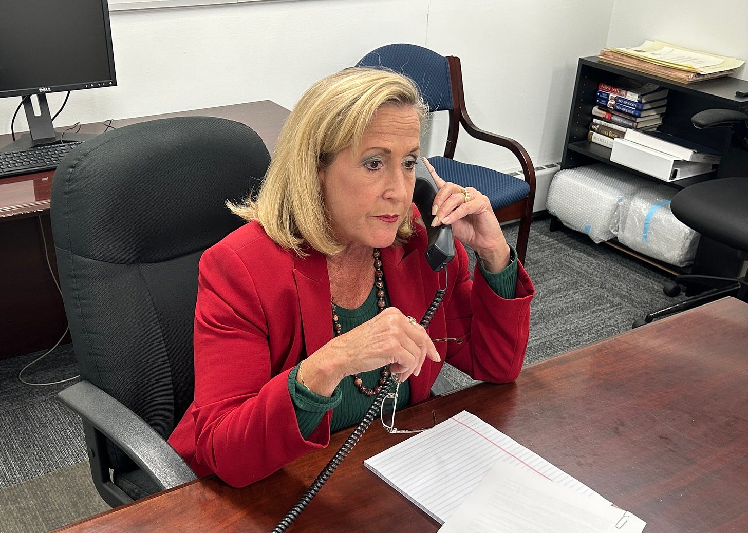 May be an image of one or more people, phone and newsroom