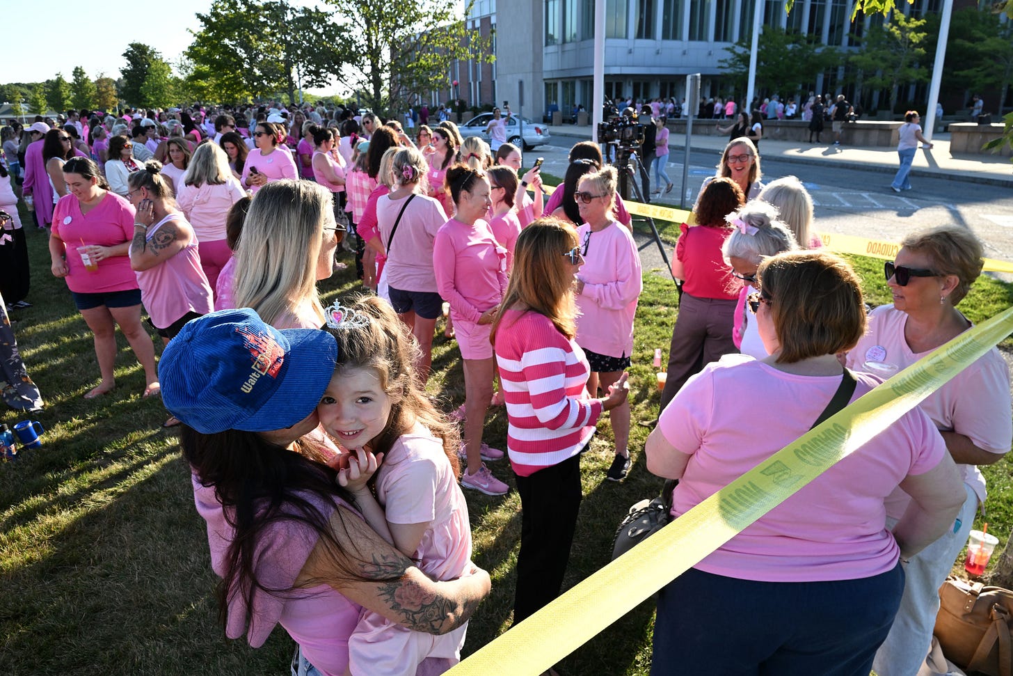 Women in pink rally in support of Lindsay Clancy at her tria...
