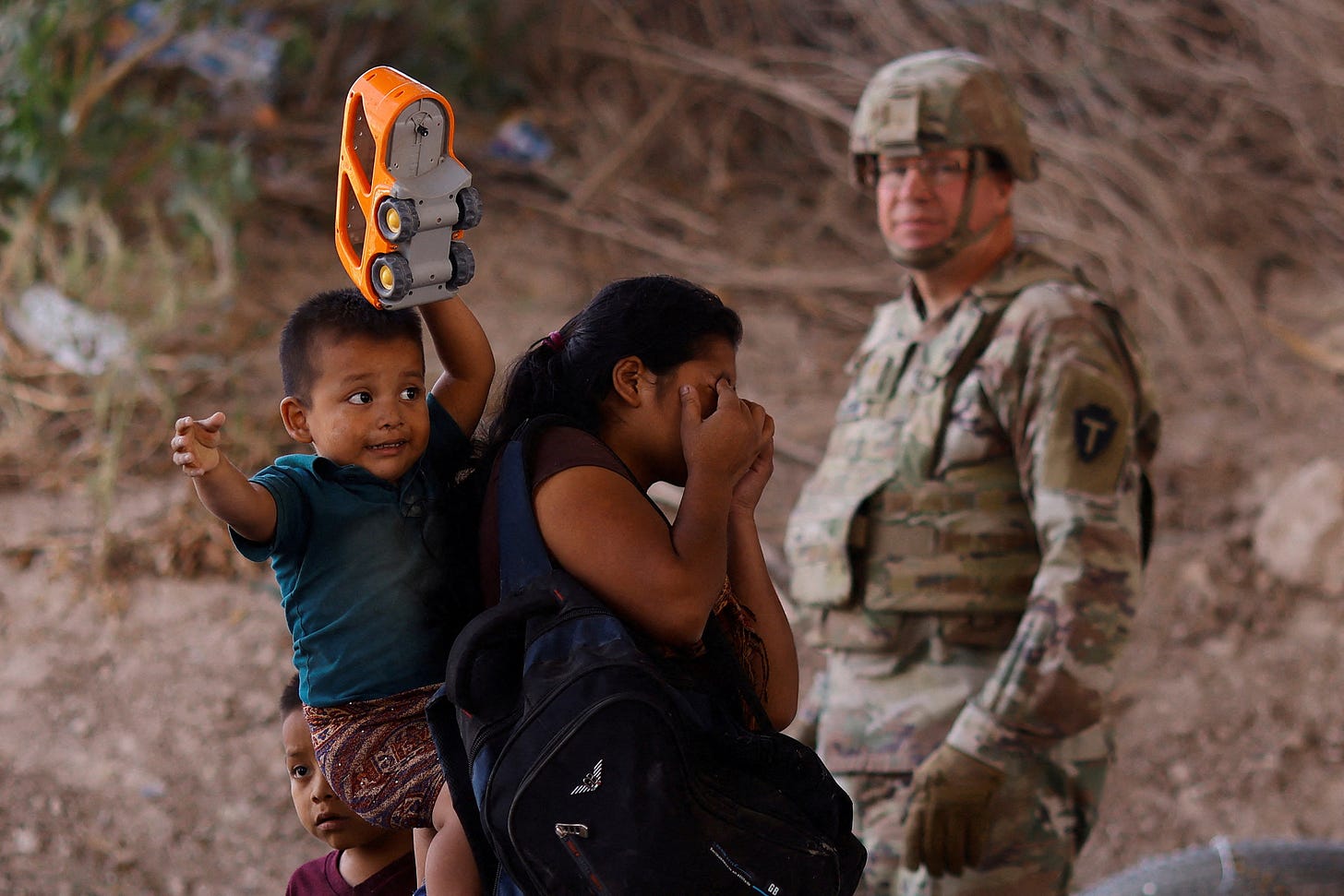 Migrants stand near the Rio Bravo river after crossing the border, to request asylum in the United States, as seen from Ciudad Juarez Migrants stand near the Rio Bravo river after crossing the border, to request asylum in the United States, as seen from Ciudad Juarez