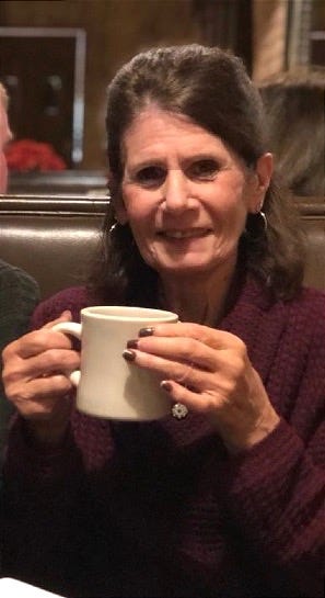 A person holding a white mug

AI-generated content may be incorrect.