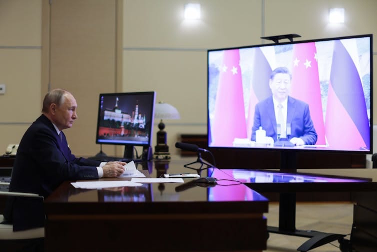 Russian president Vladmir Putin talks with Chinese president Xi Jinping over video link from the Kremlin. Russian president Vladmir Putin talks with Chinese president Xi Jinping over video link from the Kremlin.