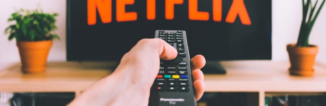 person holding remote pointing at TV person holding remote pointing at TV