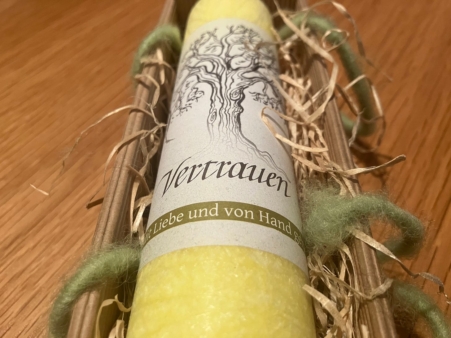 yellow candle with imprint that says trust